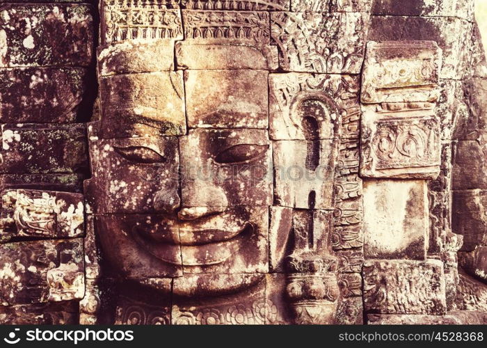 Stone faces of ancient Khmer culture temple of Bayon in Angkor area near Siem Reap, Cambodia