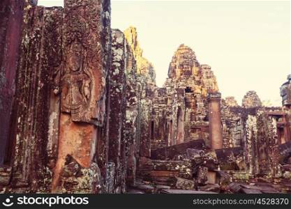 Stone faces of ancient Khmer culture temple of Bayon in Angkor area near Siem Reap, Cambodia