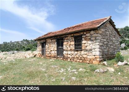 Stone farm house and green grass in Turkey