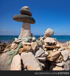 Stone figures on beach shore of Illetes beach in Formentera Mediterranean Balearic Islands