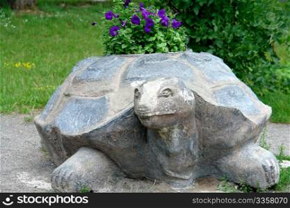 stone flowerbed in park in form of the turtle