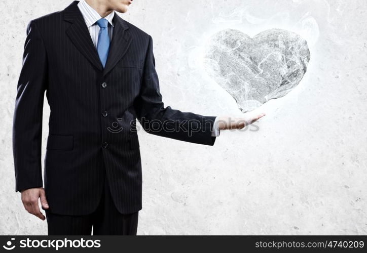 Stone heart. Businessman holding stone in shape of heart in palm