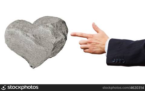 Stone heart. Businessman pointing at stone in shape of heart