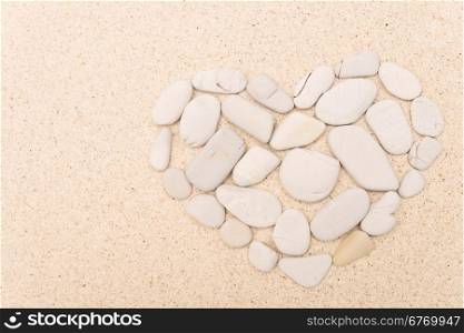 stone heart on a sand