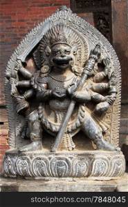 Stone hindu god near temple in Bhaktapur, Nepal