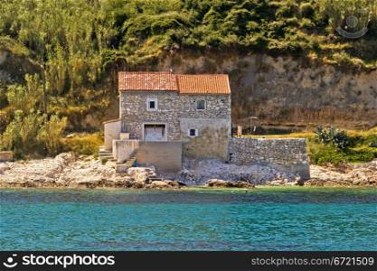 Stone house on the beach in dalmatian Island of Susak, Croatia