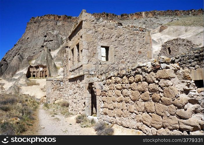 Stone houses and rock church in village Selime in Ihlara valley in Cappadocia, Turkey