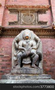 Stone idol near the wall on Durbar square in Patan, Nepal