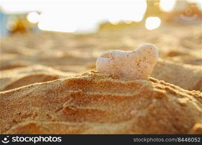 stone in the form of a heart in the sand on the beach.. stone in the form of a heart in the sand on the beach