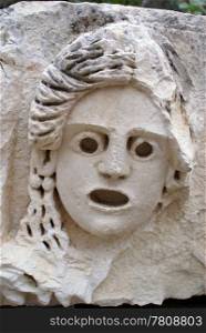 Stone mask on ruins of theater in Myra, Turkey