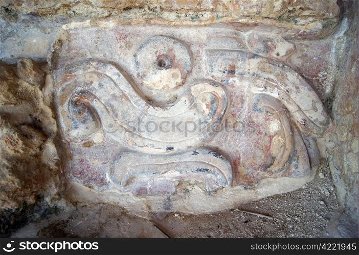 Stone mayan god on the wall of piramid in Edzna, Campeche, Mexico