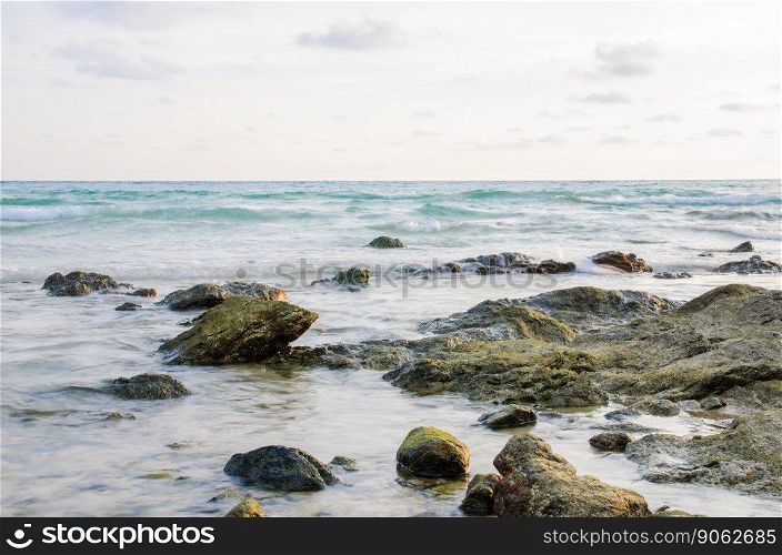 stone on beach with sea
