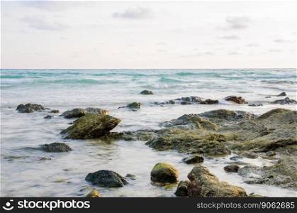 stone on beach with sea