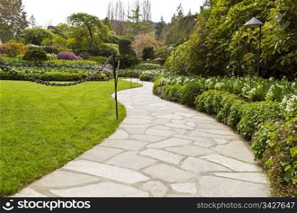 Stone pathway into garden during day time