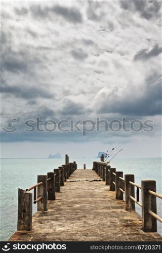 stone pier under dark clouds, Andaman Sea, Thailand