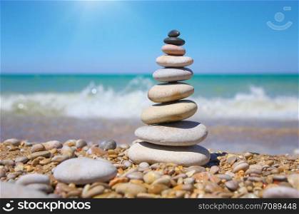 Stone pyramid on a seashore. Relax composition.