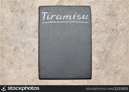 Stone serving menu board with chalk handwritten Tiramisu sign.. Stone serving menu board with chalk handwritten Tiramisu sign