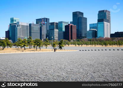 Stone square garden with modern office building in Japan .