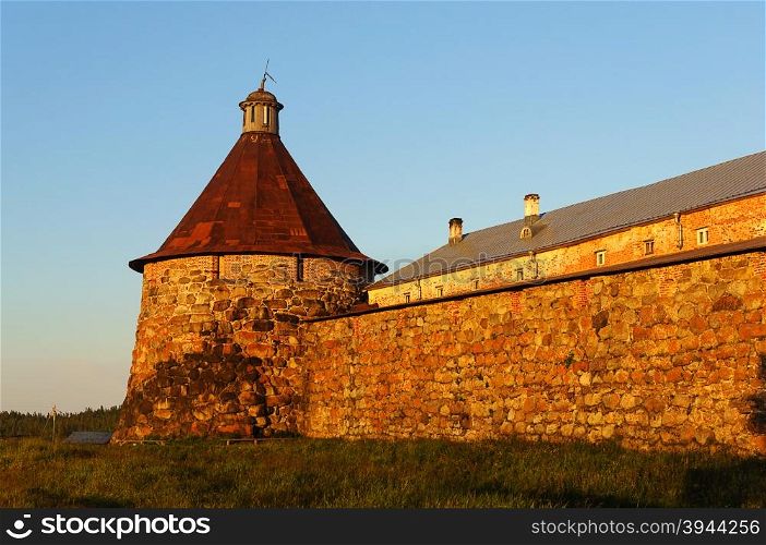 Stone tower and wall of the Solovetsky monastery on Solovki (Solovetsky archipelago), sunset. UNESCO World Heritage Site.