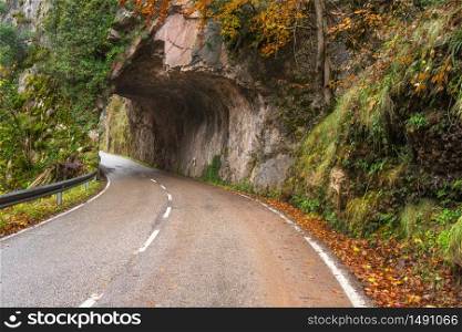 Stone tunnel road in mountain scenary in Somiedo natural park, Asturias, Spain.