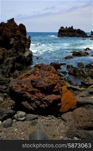 stone volcanic spain water coast in lanzarote sky cloud beach and summer &#xA;
