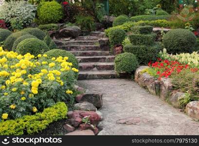 stone walkway in flower garden