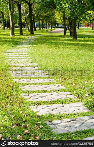Stone walkway into woods in the park