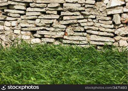 Stone wall and green grass