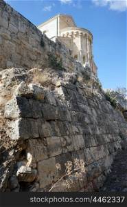 Stone wall and Transfiguration church on the top of Tavor mount, Israel