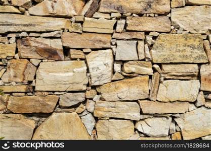 Stone wall background texture. Decorative dry masonry