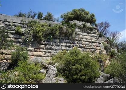 Stone wall of ancient town Pednelissos in Turkey