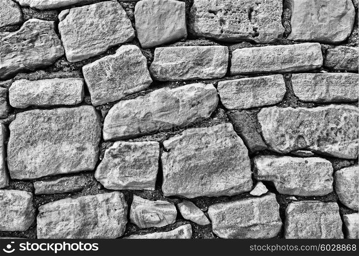 stone wall of large stones, black and white