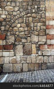 Stone wall on the street in Old city in Jerusalem, Israel