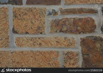 Stone wall with colors of brown, rust, tan, and grays