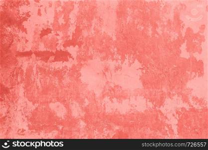 Stone wall with cracked, peeling plaster and paint as texture, background, coral toned.. Stone wall with cracked, peeling plaster and paint as texture, background, coral toned