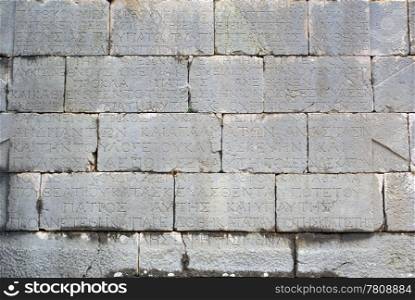 Stone wall with letters in Patara, Turkey