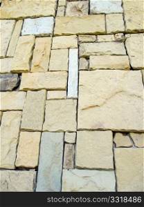 Stone wall with light brown and beige natural stone