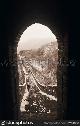 Stoned wall seen through and arch of a window, Great Wall Of China, China