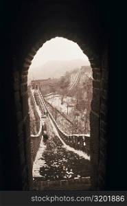 Stoned wall seen through and arch of a window, Great Wall Of China, China