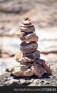 Stones balance, pebbles stack over blue sea