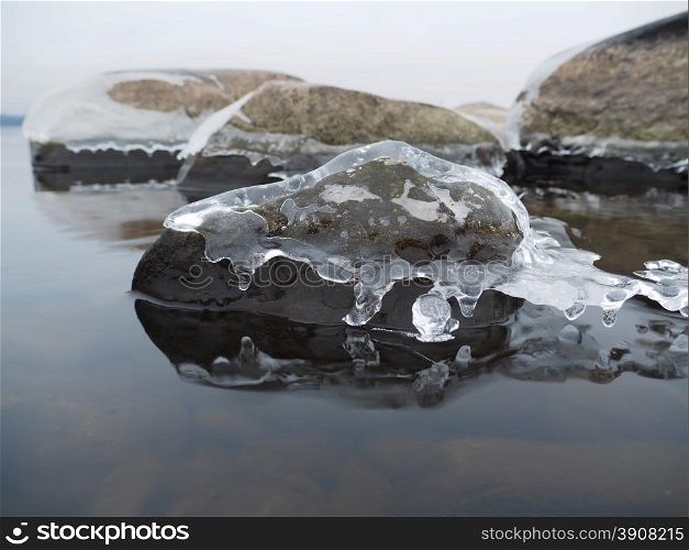 stones in the ice on the lake
