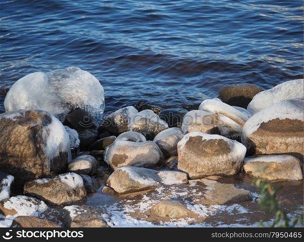 stones in the ice on the lake