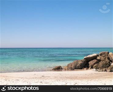 Stones on the beach in Vada, transparent, turquoise water and white sand. Travel and nature concept.. Beach in Vada, Italy.