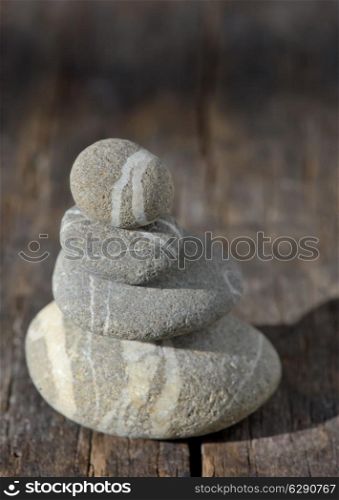 Stones pyramid on wooden symbolizing zen, harmony, balance