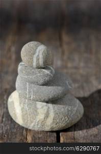 Stones pyramid on wooden symbolizing zen, harmony, balance
