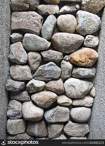 Stones stacked to make up part of a wall.