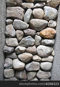 Stones stacked to make up part of a wall.