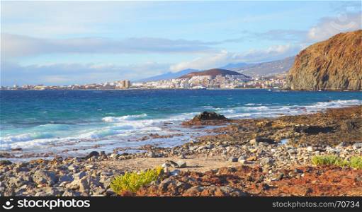 Stony beach and Las Americas and Los Cristianos towns in the background, Tenerife Island, Canaries
