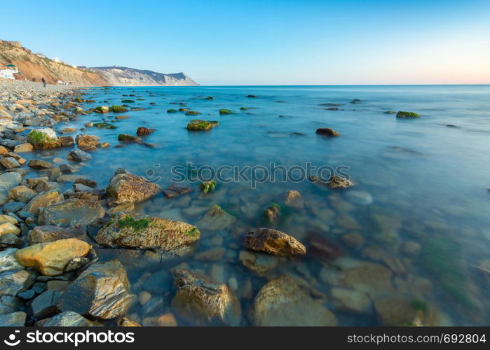 Stony sea beach of the 40th anniversary of the victory of the high coast of Anapa at sunset, Black Sea, Anapa, Russia