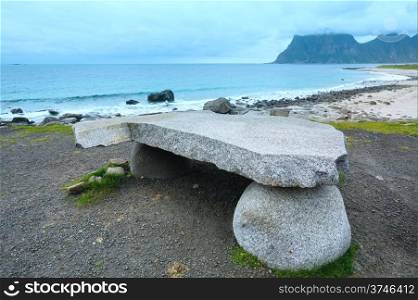 Stony table on Haukland beach. Summer cloudy view (Norway, Lofoten).